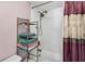 Bright bathroom featuring a shower and bath combination, decorative curtain and ample storage at 15925 Marshfield Dr, Tampa, FL 33624