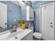 Bright bathroom features blue walls, a sink, toilet, and stylish decor at 15925 Marshfield Dr, Tampa, FL 33624