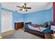Colorful bedroom featuring fun colors, a ceiling fan, and a closet for storage at 15925 Marshfield Dr, Tampa, FL 33624