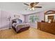 Comfortable bedroom with natural light, wood floors, neutral colors and two dressers at 15925 Marshfield Dr, Tampa, FL 33624