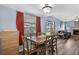 Cozy dining room with wooden table and chairs, with view to outdoor playground and open floorplan to living area at 15925 Marshfield Dr, Tampa, FL 33624