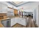Open kitchen view into living area featuring stainless steel appliances and hardwood floors at 15925 Marshfield Dr, Tampa, FL 33624
