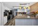 Well-lit kitchen with white cabinetry, stainless steel appliances, and modern countertops at 15925 Marshfield Dr, Tampa, FL 33624