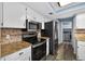 Updated kitchen featuring sleek stainless steel appliances and a stylish backsplash at 15925 Marshfield Dr, Tampa, FL 33624