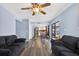 Open floor plan view of living room, dining room, and kitchen with wood look floors and pool view at 15925 Marshfield Dr, Tampa, FL 33624