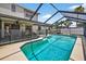 Beautiful pool is surrounded by a screened enclosure and a spacious patio at 15925 Marshfield Dr, Tampa, FL 33624