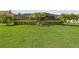 Expansive backyard with lush lawn, neatly trimmed hedges, and a screened-in lanai perfect for outdoor living at 165 Mobbly Bay Dr, Oldsmar, FL 34677