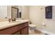 Bathroom with a shower with glass doors, marble vanity, and brown cabinets at 165 Mobbly Bay Dr, Oldsmar, FL 34677