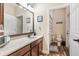 Well-lit bathroom with a large mirror, vanity, and a shower/tub combo at 165 Mobbly Bay Dr, Oldsmar, FL 34677