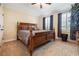 Spacious bedroom showcasing a stately wooden bed frame and bright natural lighting at 165 Mobbly Bay Dr, Oldsmar, FL 34677