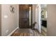 Inviting foyer features a decorative dark wooden door, wood floors and neutral colored walls at 165 Mobbly Bay Dr, Oldsmar, FL 34677