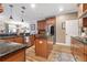 Spacious kitchen boasting a central island, granite counters, stainless appliances, and wood flooring at 165 Mobbly Bay Dr, Oldsmar, FL 34677