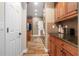 Galley kitchen with wood cabinets, granite countertops, and stainless steel appliances at 165 Mobbly Bay Dr, Oldsmar, FL 34677