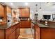 Open layout with granite countertops, stainless steel appliances, kitchen island, and wooden cabinets at 165 Mobbly Bay Dr, Oldsmar, FL 34677