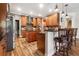 Open kitchen featuring wood cabinets, stainless steel appliances, an island, and bar seating at 165 Mobbly Bay Dr, Oldsmar, FL 34677