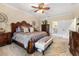 Luxurious main bedroom with a large bed, ceiling fan, and carpeted floors at 165 Mobbly Bay Dr, Oldsmar, FL 34677