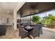Screened patio with ceiling fans, dining and lounge furniture with green, leafy outdoor views at 165 Mobbly Bay Dr, Oldsmar, FL 34677