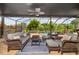 Screened patio with ceiling fans, lounge furniture and view of pool and landscaped yard at 165 Mobbly Bay Dr, Oldsmar, FL 34677