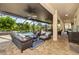 Covered lanai featuring wicker furniture with blue cushions, overlooking the pool, spa, and backyard at 165 Mobbly Bay Dr, Oldsmar, FL 34677