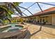 Outdoor swimming pool with attached hot tub, screened lanai and lounge furniture at 165 Mobbly Bay Dr, Oldsmar, FL 34677