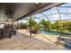 Lanai with pool, hot tub, and dining and lounge furniture at 165 Mobbly Bay Dr, Oldsmar, FL 34677