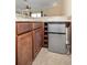 Cozy wet bar featuring wood cabinets, granite countertop and mini refrigerator at 165 Mobbly Bay Dr, Oldsmar, FL 34677