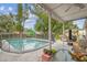 Inviting outdoor patio with a view of the pool and lush backyard, perfect for entertaining and relaxation at 1711 W Followthru Dr, Tampa, FL 33612