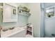 Bathroom featuring a modern sink, mirror, and toilet with decoratively styled shelves at 1711 W Followthru Dr, Tampa, FL 33612