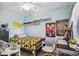 Fun bedroom featuring a window, ceiling fan, tiled floors, and cartoon character-themed decorations at 1711 W Followthru Dr, Tampa, FL 33612
