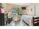 Bedroom featuring a window and tiled floors with cartoon character-themed decorations at 1711 W Followthru Dr, Tampa, FL 33612