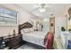 Comfortable bedroom featuring tiled floors, a ceiling fan, and a classic-style bed frame at 1711 W Followthru Dr, Tampa, FL 33612