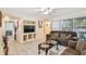 Comfortable living room featuring neutral paint, tile flooring, and a cozy seating area for Gathering and guests at 1711 W Followthru Dr, Tampa, FL 33612