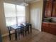 Cozy breakfast nook with tile flooring, a dark wood table, and abundant natural light from a large window at 1753 Open Field Loop, Brandon, FL 33510