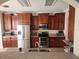 Well-equipped kitchen with stainless steel appliances, granite countertops, and rich brown cabinets, providing ample storage at 1753 Open Field Loop, Brandon, FL 33510