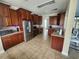 Spacious kitchen features tile floors, stainless steel appliances and wood cabinetry at 1753 Open Field Loop, Brandon, FL 33510