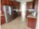 Spacious kitchen features tile floors, stainless steel appliances and wood cabinetry at 1753 Open Field Loop, Brandon, FL 33510