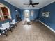 The living room has tile flooring, blue walls, and lots of natural light at 1753 Open Field Loop, Brandon, FL 33510