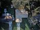 Overhead view of a single-story residence with a large backyard and mature trees at 2063 De Carlo Ave, Spring Hill, FL 34608