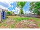 Spacious backyard features a shed, mature trees, and a partial fence, offering plenty of room at 2063 De Carlo Ave, Spring Hill, FL 34608