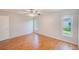 Bedroom with natural light, wood-look floors, and a ceiling fan at 2063 De Carlo Ave, Spring Hill, FL 34608