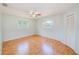 Spacious bedroom with wood floors, ceiling fan and windows at 2063 De Carlo Ave, Spring Hill, FL 34608