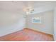 Bright bedroom features wood floors, a ceiling fan, a window, and a closet at 2063 De Carlo Ave, Spring Hill, FL 34608