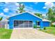 Charming blue home with a well-manicured lawn at 2063 De Carlo Ave, Spring Hill, FL 34608