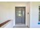 Elegant front door with glass inserts for added natural light at 2063 De Carlo Ave, Spring Hill, FL 34608