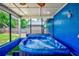 Inviting covered hot tub with blue accents and a privacy screen provides a tranquil retreat in the backyard at 2063 De Carlo Ave, Spring Hill, FL 34608