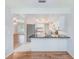 Open kitchen with a breakfast bar, white cabinets, and stainless steel appliances at 2063 De Carlo Ave, Spring Hill, FL 34608