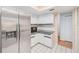 Kitchen with stainless steel refrigerator, microwave, and white tile flooring at 2063 De Carlo Ave, Spring Hill, FL 34608