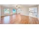 Bright living room showcasing beautiful wood floors, with views to the kitchen at 2063 De Carlo Ave, Spring Hill, FL 34608