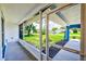 Relaxing screened porch with brick flooring offers a view of the lush, manicured front yard and neighborhood at 2063 De Carlo Ave, Spring Hill, FL 34608