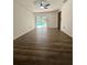 Wood-floored bedroom with backyard pool access and a ceiling fan at 2102 Doefield Ct, Valrico, FL 33596